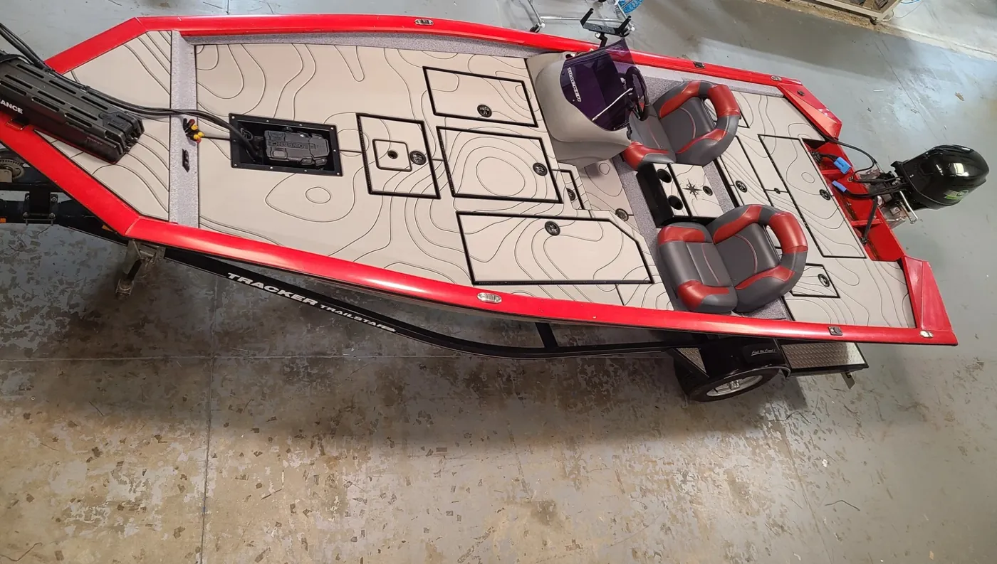 Red bass boat with grey decking featuring a topographic map design