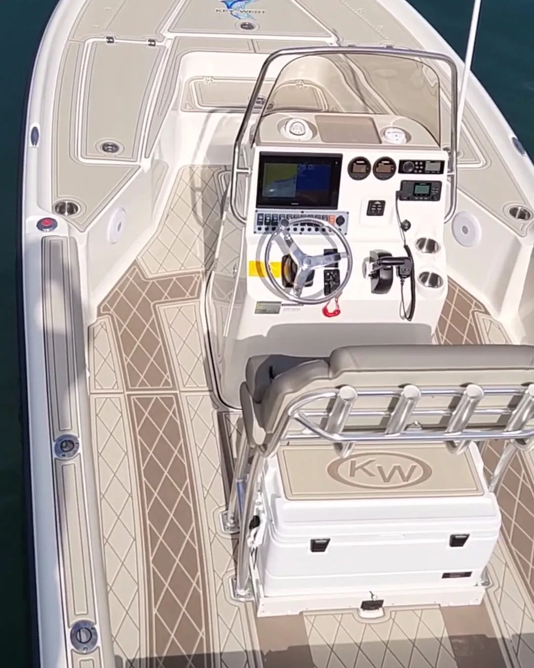 Bay boat with two-tone tan diamond-pattern decking around the center console