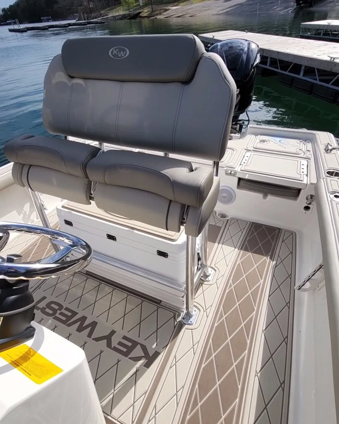 Center console boat deck with diamond pattern and an engraved brand name in the decking